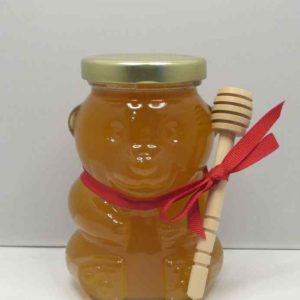 Honey bear jar with a red ribbon.