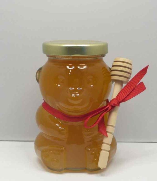 Honey bear jar with a red ribbon.